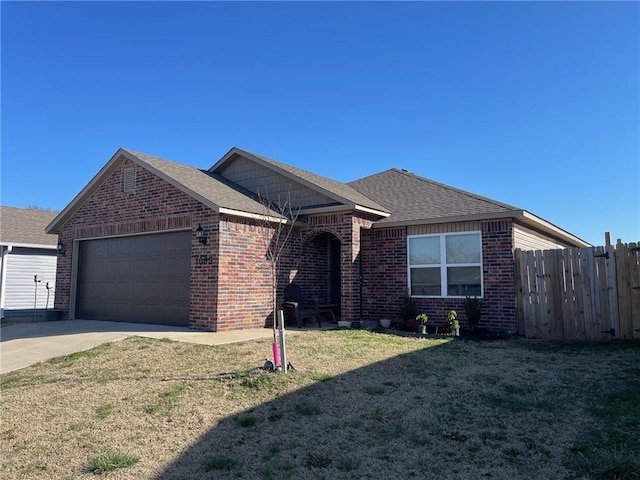 ranch-style house with brick siding, fence, a front yard, roof with shingles, and a garage