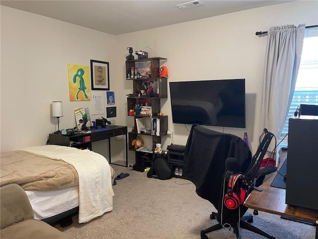 bedroom with visible vents and carpet flooring