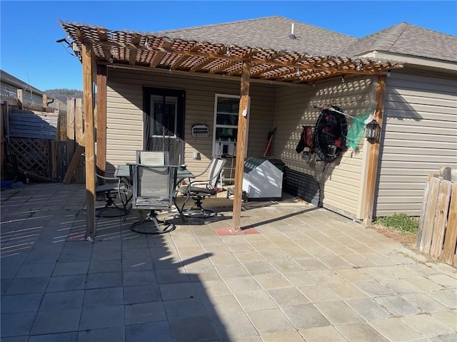 view of patio / terrace with outdoor dining space, fence, and a pergola