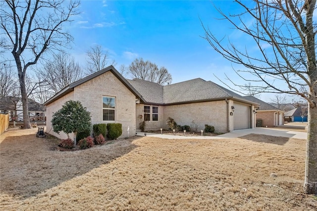 ranch-style house featuring brick siding, fence, roof with shingles, driveway, and an attached garage