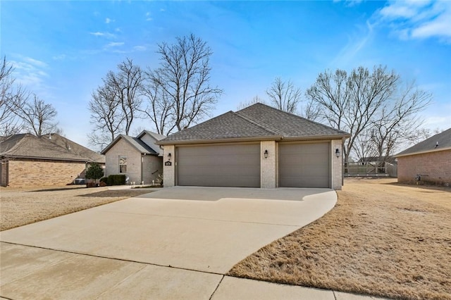 view of front of home featuring a garage, brick siding, roof with shingles, and driveway