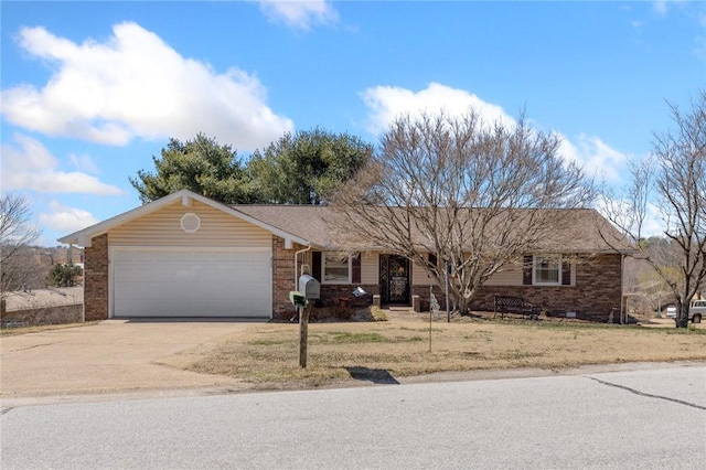 ranch-style home with concrete driveway, an attached garage, brick siding, and a front yard