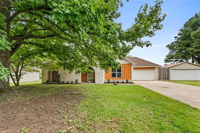 view of front of home featuring concrete driveway, an attached garage, board and batten siding, and a front yard