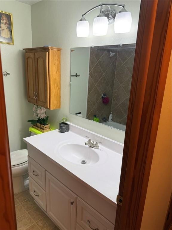 bathroom with tile patterned floors, toilet, and vanity