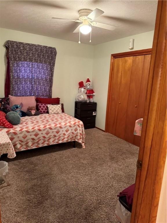 carpeted bedroom with a ceiling fan and a textured ceiling