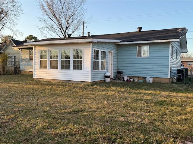 back of property with a lawn