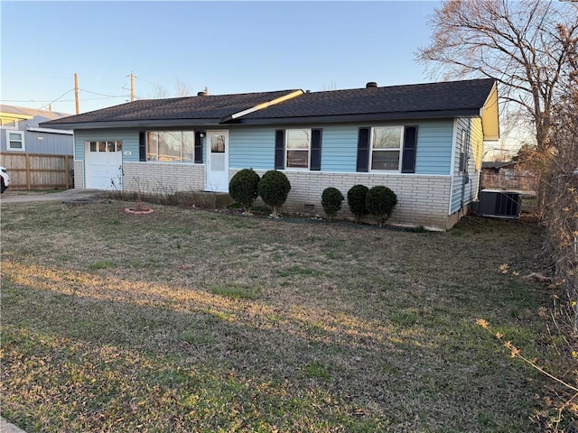 ranch-style home with a garage, fence, a front yard, crawl space, and brick siding