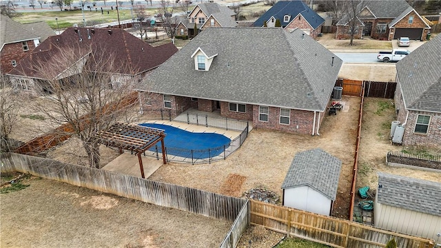 view of pool with a fenced in pool, a residential view, a fenced backyard, and a patio area