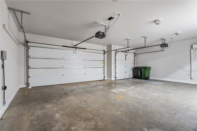 garage with baseboards and a garage door opener