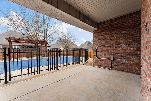 view of patio with a fenced in pool, a pergola, and fence