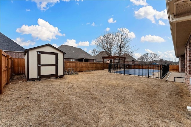 view of yard featuring a patio, an outbuilding, a fenced backyard, and a shed