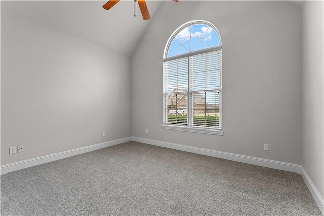 spare room with lofted ceiling, baseboards, carpet floors, and ceiling fan