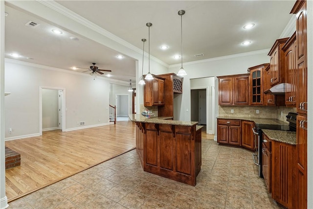 kitchen with stainless steel electric range oven, visible vents, a peninsula, glass insert cabinets, and a kitchen breakfast bar