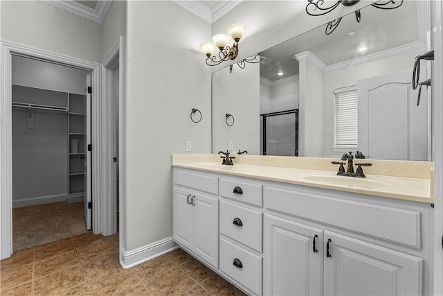 bathroom featuring a walk in closet, crown molding, a stall shower, and a sink