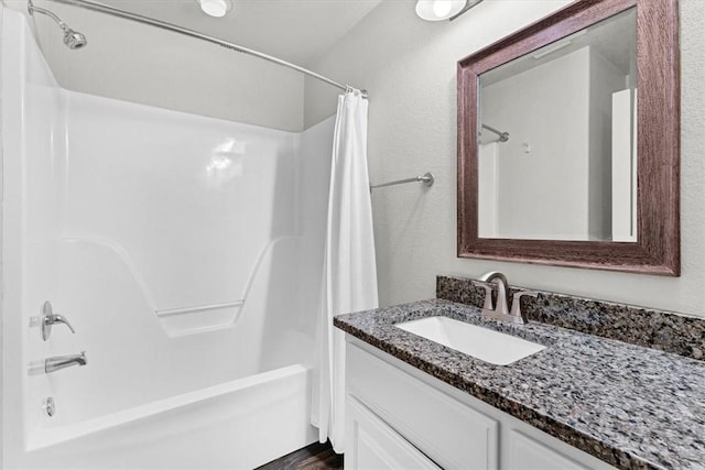 bathroom featuring vanity and shower / bath combo