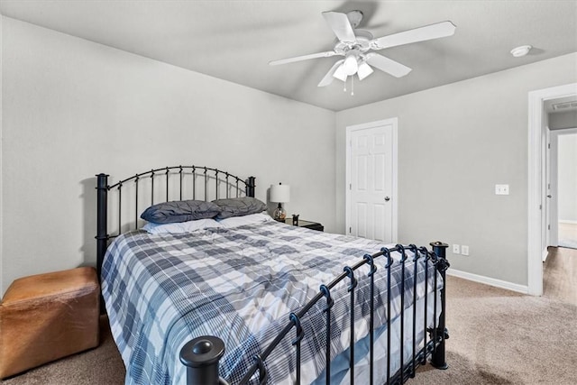 carpeted bedroom with a ceiling fan and baseboards