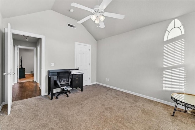 home office with visible vents, baseboards, carpet, high vaulted ceiling, and a ceiling fan