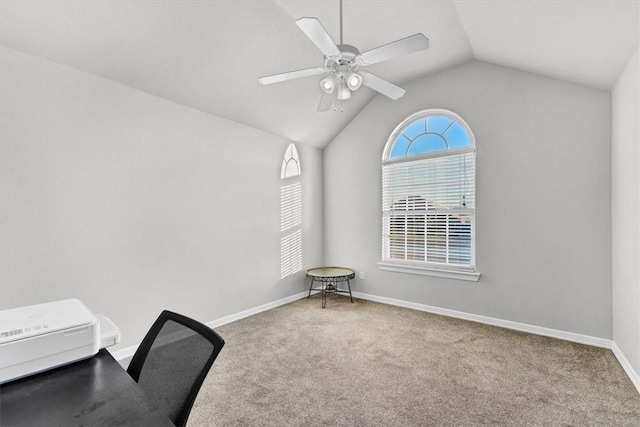 unfurnished office with baseboards, carpet, a ceiling fan, and vaulted ceiling