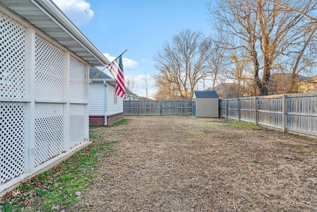 view of yard featuring an outdoor structure, a fenced backyard, and a shed