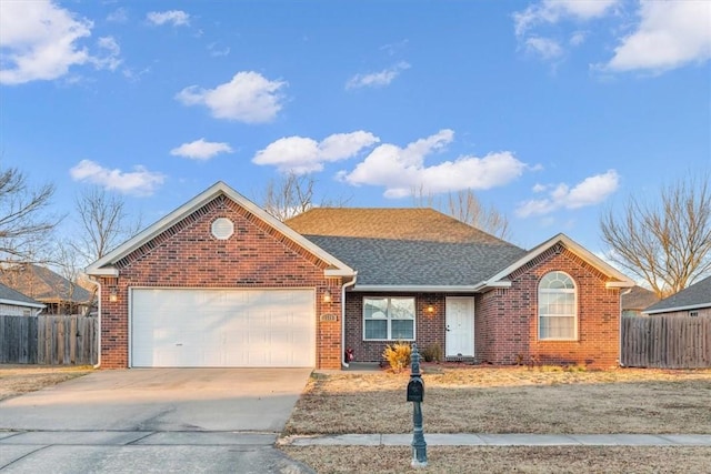 single story home with driveway, fence, a shingled roof, a garage, and brick siding