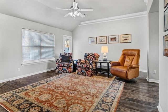 living area with vaulted ceiling, wood finished floors, baseboards, and ceiling fan