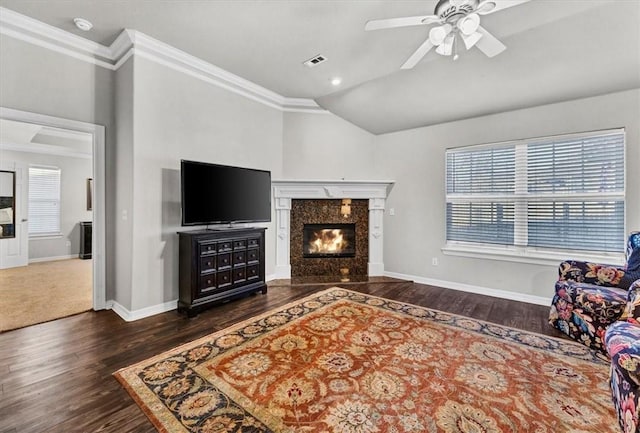 living room featuring visible vents, plenty of natural light, a fireplace, and lofted ceiling