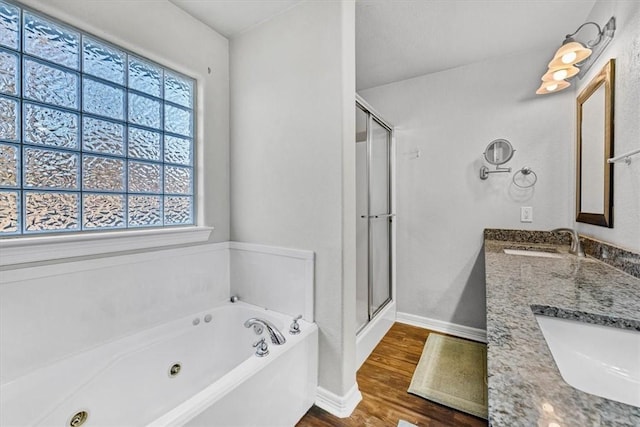 full bath featuring a shower stall, wood finished floors, a whirlpool tub, and a sink