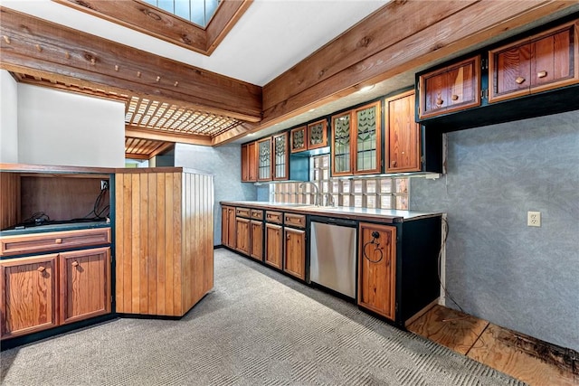 kitchen with brown cabinetry, a sink, glass insert cabinets, dishwasher, and light colored carpet