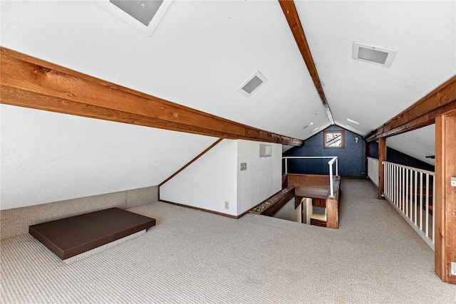 additional living space with lofted ceiling with beams and carpet