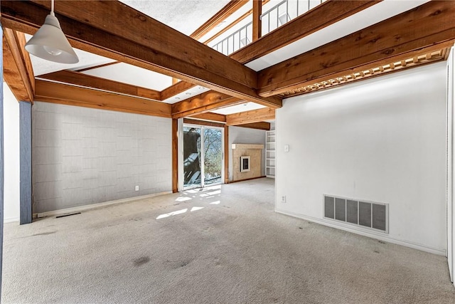 spare room with visible vents, beam ceiling, baseboards, and carpet flooring