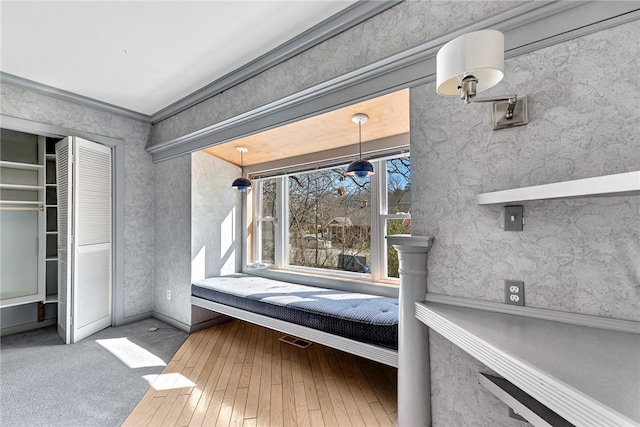 unfurnished bedroom featuring a closet, carpet floors, and ornamental molding