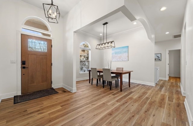 entryway with visible vents, baseboards, ornamental molding, recessed lighting, and light wood-style flooring