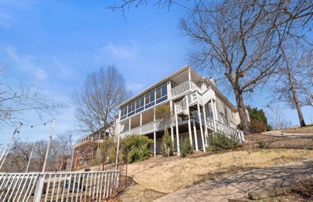 back of house with stairs and a deck