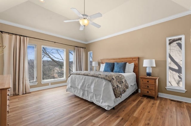 bedroom with crown molding, wood finished floors, and lofted ceiling