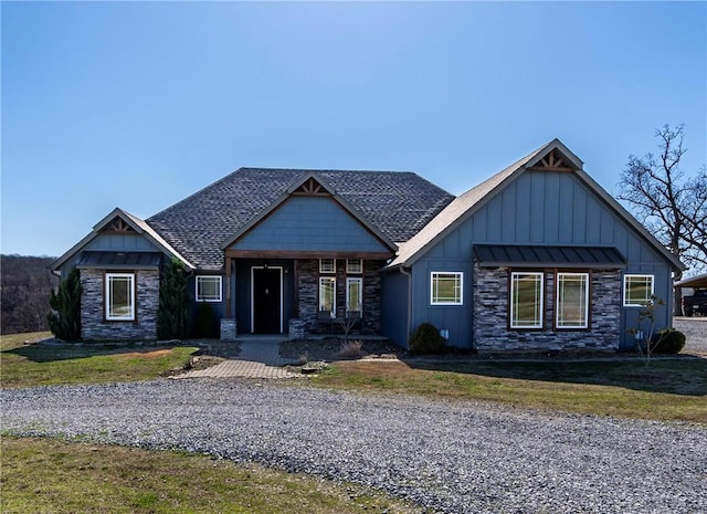 craftsman-style house featuring a front yard, roof with shingles, a porch, stone siding, and board and batten siding