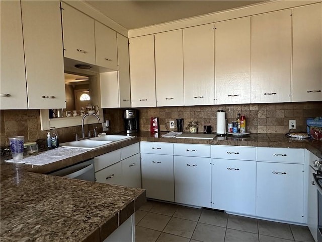 kitchen featuring light tile patterned floors, backsplash, and a sink