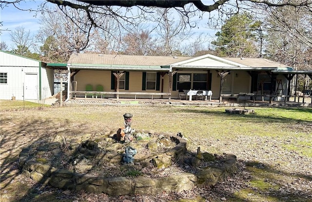 rear view of house with covered porch and metal roof