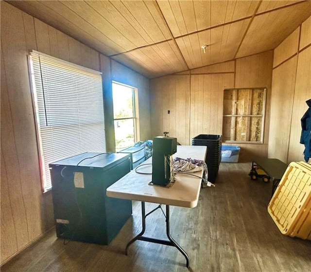 dining space featuring wood finished floors, wood ceiling, and wood walls