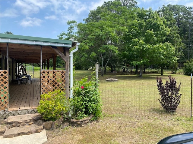 476359 791st Rd, Stilwell, OK 74960 - view of green lawn with a deck and a fire pit