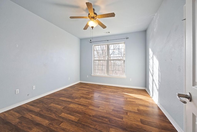 unfurnished room featuring visible vents, ceiling fan, baseboards, and wood finished floors