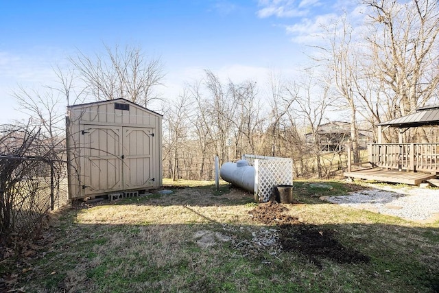 view of yard featuring a gazebo, a storage unit, an outbuilding, and a wooden deck