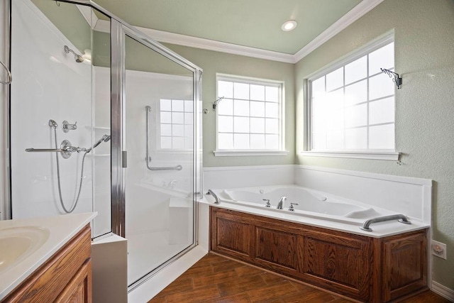 full bath with ornamental molding, wood finished floors, a shower stall, a bath, and vanity