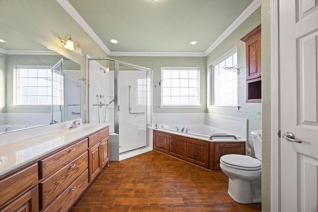 full bathroom featuring a shower stall, a garden tub, ornamental molding, wood finished floors, and vanity