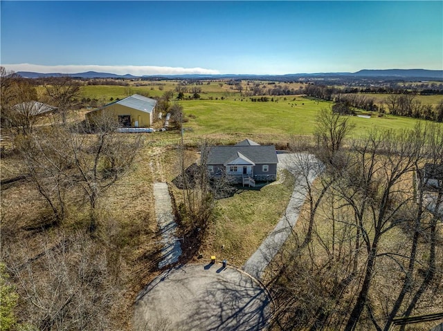 birds eye view of property featuring a mountain view and a rural view