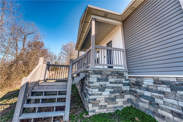 view of side of home featuring stairway