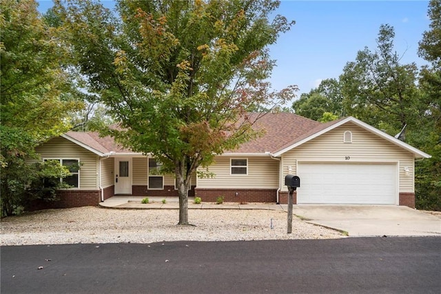 single story home featuring brick siding, an attached garage, and concrete driveway