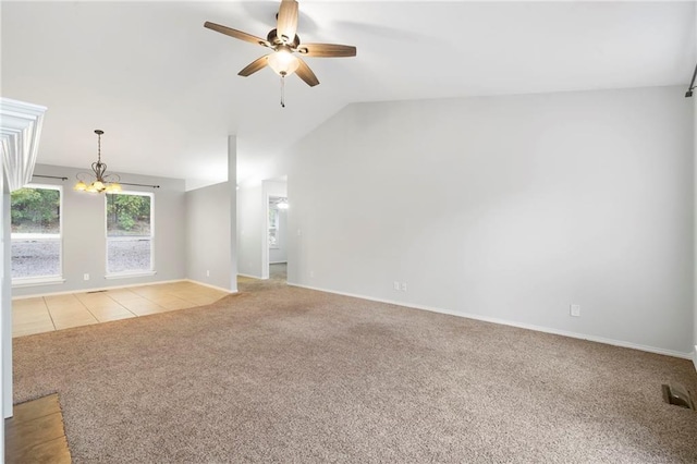 unfurnished living room with baseboards, lofted ceiling, light tile patterned flooring, light carpet, and ceiling fan with notable chandelier