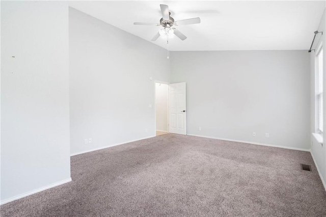 unfurnished room with baseboards, visible vents, lofted ceiling, ceiling fan, and carpet flooring