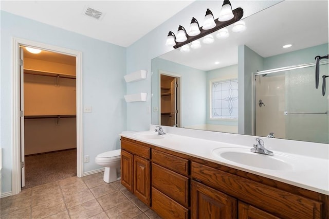 bathroom with double vanity, visible vents, a shower stall, and a sink