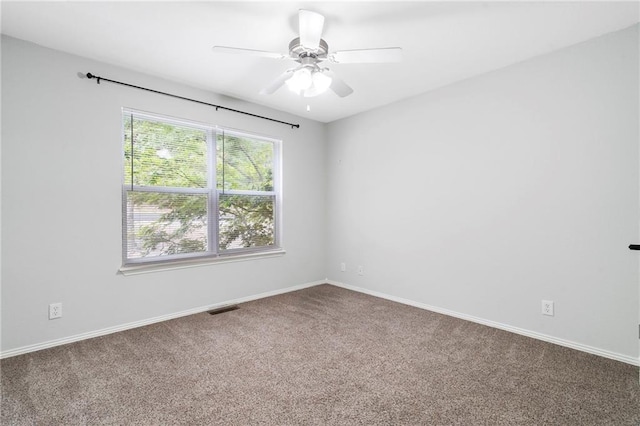 spare room with visible vents, baseboards, carpet floors, and ceiling fan